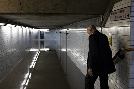 A man seen trying to walk through a flooded tunnel at Westminster Underground Station. Several underground stations are flooded this afternoon after the torrential rain lashed London. Rainwater struggles to permeate dry ground through the dehydrated surface and lead to flash flooding after torrential rain.