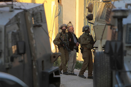 Israeli infantry soldiers arrest 60-year-old Akef during a raid on the home of his son, Musab Akef, an activist in the Hamas movement, in Salem village, in the city of Nablus in the occupied West Bank.