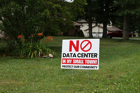 A yard sign opposing a proposed data center is displayed outside a home in Mount Carmel Township Northumberland County. In Mount Carmel Township, grassroots opposition has surged as residents display yard signs and demand a multi-year moratorium to protect their community from a massive proposed AI data center campus. The local resistance is driven by severe concerns over potential noise pollution, the industrialization of local land, and a massive strain on the power grid and water supply that could trigger utility rate hikes and local rationing.