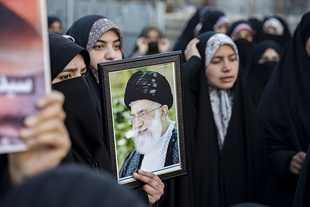 A protester hold a photograph of Ayatollah Ali Khamenei during a protest. The office of Iran’s Supreme Leader and the presidential office in Tehran were reportedly targeted in coordinated military strikes by Israel and the United States, along with military sites across the country. At least 53 people were killed at a girls’ school in the attack, according to Iranian state media reports.