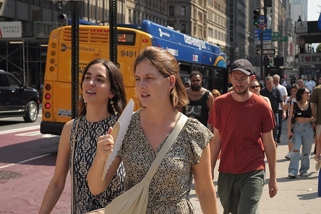 A person uses a fan while crossing the street during the third heat wave of the summer in Manhattan, New York City. New Yorkers are experiencing high temperatures in the 90s with humid weather making the weather feel hotter. Weather advisories are urging people to stay cool and hydrated amid the hot weather.