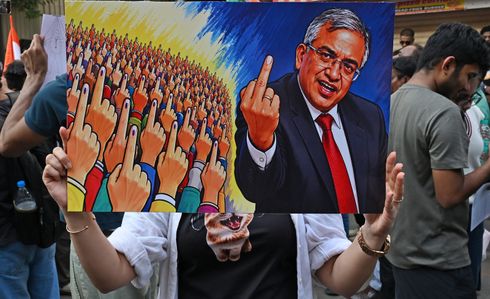 (EDITOR'S NOTE: Image depicts profanity) 
A supporter of Cockroach Janta Party (CJP) holds a placard during a protest demanding resignation of Gyanesh Kumar, Chief Election Commissioner (CEC) of India. Cockroach Janta Party (CJP) supporters gathered in huge numbers near Shivaji park (an area in Central Mumbai) carrying placards with witty message demanding resignation of Gyanesh Kumar, Chief Election Commissioner (CEC) of India over allegation of voter list manipulation during the verification of country's voter population under Special Intensive Revision (SIR).