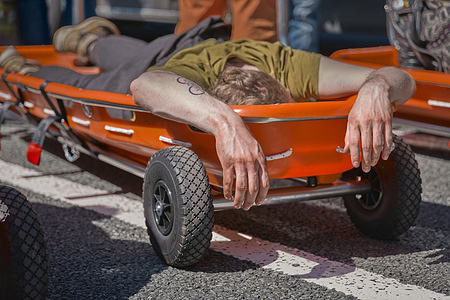 Arrested activist refusing to walk during the A12 blockade in Utrecht, lying on a stretcher while waiting for transport. Climate activists from Extinction Rebellion, Debt for Climate, and Utrecht for Palestine blocked the A12 ring road near De Meern (at knooppunt Oudenrijn) in Utrecht. They protested to demand an immediate end to Dutch fossil fuel subsidies, which they say amount to thirty-nine point seven billion euros to forty-six point four billion euros (€39.7–€46.4 billion) annually and exacerbate the climate crisis.