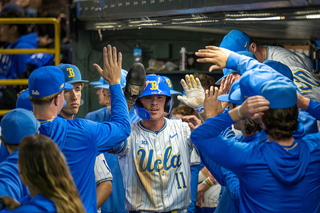 Outfielder Payton Brennan (11) of the UCLA Bruins celebrates run with team during a Big Ten conference baseball game against the USC Trojans at Jackie Robinson Stadium on April 3, 2026 in Los Angeles, California.