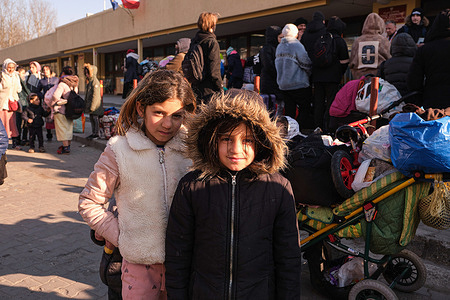 Ukrainian girls wait at the station to catch a train back to Ukraine. The war in Ukraine has forced millions of Ukrainians to leave their country destroyed in a horrendous war. Carrying the bare minimum, women and children have crossed the border to settle in Poland and other European countries with the sole desire to return soon.