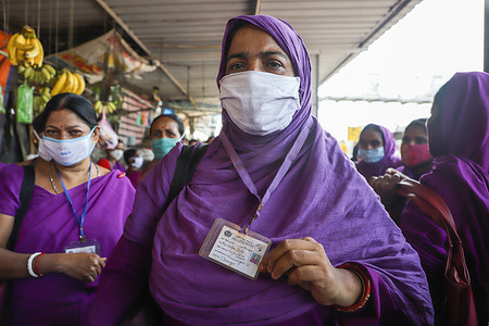 An ASHA (Accredited Social Health Activist) worker shows her identity card during the protest against the West Bengal government over the non-payment of their salaries for the last 6 months as well as their pending bonus before festivals and non payment of mobile bills.