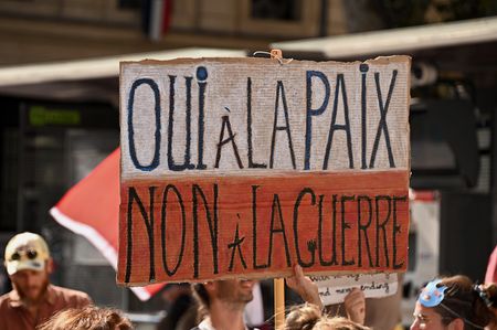 A protester holds a placard saying "Yes to peace, no to war" during the demonstration. Demonstrators are marching through the streets of Marseille for the climate, the natural world, peace, and social justice.