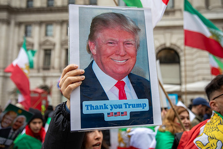 An Iranian Monarchist holds a picture of American President Donald Trump during a demonstration in Central London. As the war between the United States, Israel and Iran entered its second week, supporters of Crown Prince Reza Pahlavi gathered in central London for a march and rally. Demonstrators voiced support for the US-led military action and called for the exiled son of the former Shah to serve as a unifying figurehead should Iran’s current regime be overthrown.