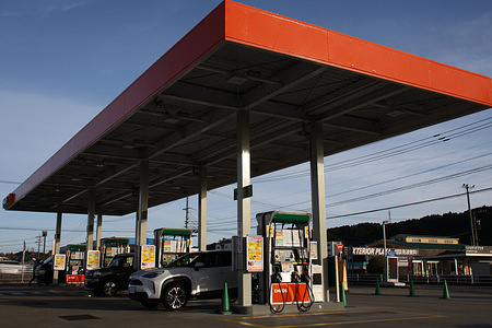 A customer refuels at an ENEOS gas station in Chuo Ward. Operators say the price per liter has been raised and customer numbers are declining as gasoline prices surge amid rising crude oil costs linked to tensions in the Middle East. Some operators are calling for the situation to ease.