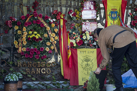 A man cleans the altar next to the tomb of dictator Francisco Franco during the anniversary. The altar remains adorned with flowers and Francoist flags, on the 50th anniversary of the death of the Spanish dictator Francisco Franco, whose remains rest in the Mingorrubio cemetery in El Pardo, Madrid. Franco died on November 20, 1975, at the age of 82, after ruling Spain for almost forty years.