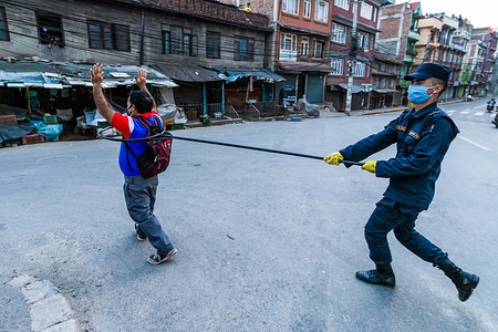 A police officer maintains a safe distance as he detains a man defying the lockdown regulations.
The government imposed a nationwide lockdown amid concerns about the spread of Corona virus (COVID-19) outbreak.