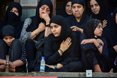 Kashmiri Shiite Muslim women look on during mourning rituals to mark Ashura. Ashura is the tenth day of Muharram, the first month of the Islamic calendar, observed around the world in remembrance of the martyrdom of Imam Hussain, the grandson of Prophet Muhammad (PBUH).