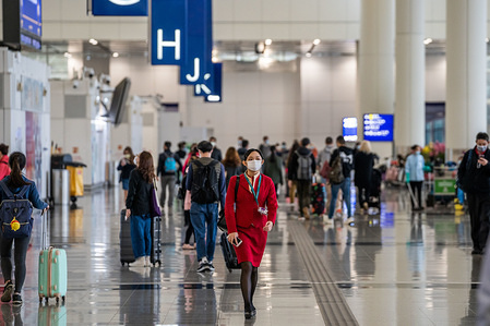 A Cathy Pacific flight attendant seen wearing surgical mask as a protective measure from the deadly coronavirus at the Hong Kong international airport.
Hundreds of flights between mainland Chinese cities and Hong Kong cancel as the 14 days mandatory quarantine measure which travelers will have to stay at home or hotel to be quarantined takes into effect.