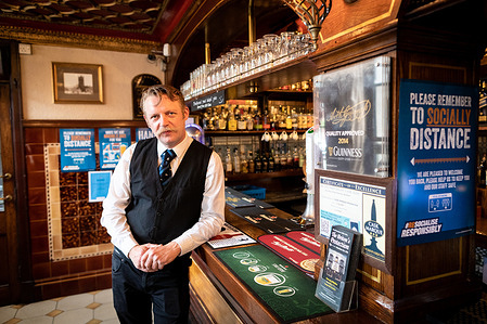 Manager, Tor Sagan poses for a photo inside The Britons Protection pub ahead of what has been dubbed Super Saturday.
Pubs, restaurants, hairdressers and cinemas in England are opening their doors for the first time in three months after a major relaxation of coronavirus lockdown restrictions.