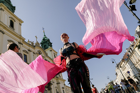A woman dances while marching in the parade column during the event. Thousands of people took part in the Equality Parade in Warsaw, which advocates for LGBTQ+ rights and broader social inclusion. This year’s march took place shortly after Poland’s presidential election, won by Karol Nawrocki, a candidate supported by the conservative Law and Justice party. While the event remained peaceful, banners and stands expressing opposition views were visible along parts of the route.
