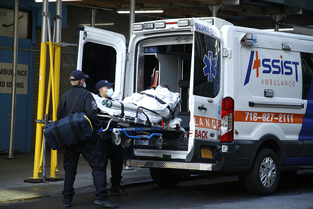 Emergency medical technicians move a COVID-19 patient from Mt. Sinai Morningside Hospital into an ambulance.
Hospitals in New York City, have been hard hit by COVID-19 pandemic and are facing shortages of beds, ventilators and protective equipment, in addition to extremely long shifts for the medical staff.