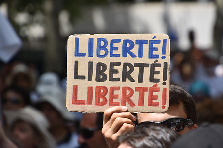 A protester holds a placard during the demonstration against the health pass in Marseille.
More than 8,000 people demonstrated against the health pass in Marseille, France. French President Emmanuel Macron announced among new anti-Covid 19 measures a "health pass" that will be necessary to frequent café terraces, restaurants, cinemas, theatres, and other culture and leisure activities to help contain the spread of the Covid-19 virus.