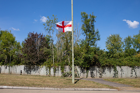 A St George's flag is flown from a lamp post. The campaign to display British and English flags on lamp posts across the UK now extends to Surrey. It is seen by some to be a show of national pride and patriotism, to others as a symbol of racist division.