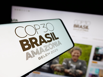 In this photo illustration, a smartphone with the logo of UN climate change conference COP30 in Brazil is seen on screen in front of website.