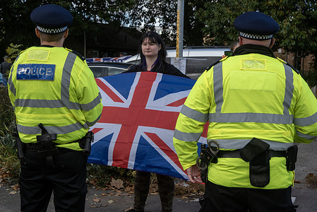 A protester holds a Union Jack during the protest outside the Connors House. Around hundred far-right UKIP and Reform UK protesters gathered for an anti-immigration demonstration by the Connors House. The Connors House is a home for unaccompanied asylum-seeking children in Canterbury, UK.