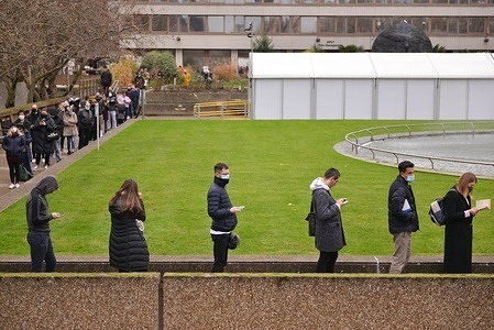 People are waiting in a line at Covid-19 Vaccination Centre at St Thomas' Hospital, London.