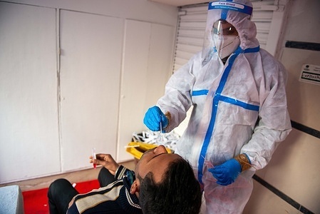 A health worker taking a nose swab from a man for a RT-PCR test at connaught place.
The Covid-19 rate in India is going down according to the Health Minister of India.