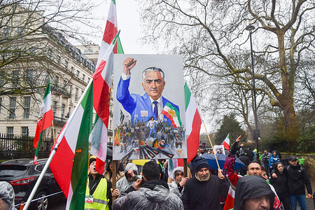 Pro-monarchy protesters hold a picture of Reza Pahlavi during the demonstration near the Embassy of Iran. Supporters of Reza Pahlavi, the Crown Prince of Iran, and members of the Kurdish community staged separate protests outside the Embassy of Iran against the Islamic Republic following Iran’s protest crackdown, before clashes broke out between the two groups.