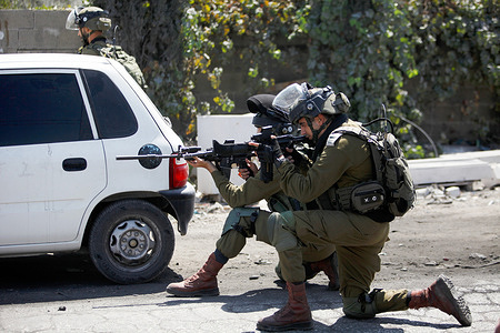 Israeli soldiers fire tear gas at Palestinians protesters during the demonstration.Palestinians protest against the construction of a new road for Israeli settlers, and also call for the removal of the Israeli outpost Eviatar near Beita, south of Nablus in the West Bank.
