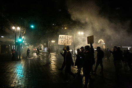 A protester raises a placard that reads, "ABOLISH ICE" during the protest.
Protests broke out in Portland, Oregon when only one of three officers involved in Breonna Taylor's death was indicted with first-degree wanton endangerment charges.