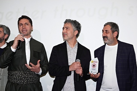 Rezan Yesilbas (M), the director of the film "Ucan Kofteci" (The Flying Meatball Maker), and Nazmi Kirik (R), the lead actor, are seen at the ceremony held after the film screening. The film Ucan Kofteci (The Flying Meatball Maker), directed by Rezan Yesilbas and starring the famous actor Nazmi Kirik, was screened at the 3rd Amed International Film Festival in Diyarbakir in Turkey.