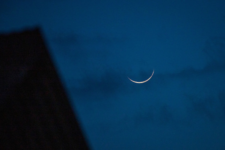 The crescent moon or Ramadan moon rises over the sky on the first day of the holy fasting month of Ramadan in Srinagar. The sighting of a new crescent moon marks the start of holy month of Ramadan. Muslims around the world anticipate the sighting of the new crescent moon that signifies the official first day of Ramadan, the ninth month of the Islamic calendar and the most sacred month in Islamic culture.