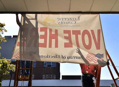 Luzerne County employees raise a banner outside of the elections bureau in Wilkes-Barre advising voters where to drop their mail-in-ballots.
Voting in Luzerne County began today, voters walk into the bureau of elections and ask for a mail-in-ballot and deposit it in a box at the location. Luzerne County elections bureau was investigated after finding 9 military ballots in the trash 3 weeks ago.