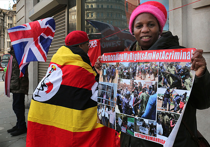 Protesters wrapped in Ugandan flags hold placards criticising the Museveni government as they demonstrate outside the Ugandan consulate. Protesters demonstrated against Yoweri Museveni’s landslide election win on Saturday (17/01/26). The election campaign was marred by violence and allegations of fraud. His opponent former singer Bobi Wine has alleged mass fraud amid an internet blackout during the election period. Museveni has ruled Uganda for 40 years and has changed the country’s constitution to allow him to continue in office.