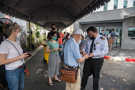 An embassy guard seen checking the documents of French nationals living in Thailand before they cast their votes for the presidential elections outside the Embassy of France. French nationals living in Thailand vote in the second round of the French presidential elections with current President Macron running against far-right Rassemblement National party (RN or National Rally) candidate, Marine Le Pen at the Embassy of France in Bangkok.