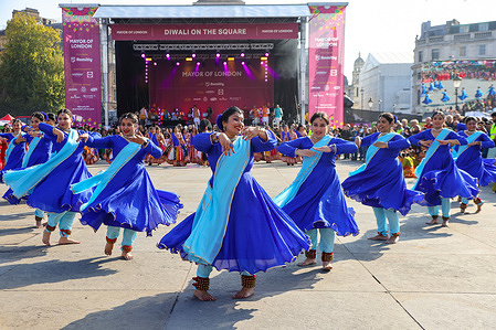 Dancers in colourful blue outfit perform an opening dance to begin Diwali on the Square celebrations at Trafalgar Square. Hindus, Sikh and Jains around the world celebrate Diwali, the Indian festival of lights which symbolises the triumph of light over darkness, good over evil and knowledge over ignorance.