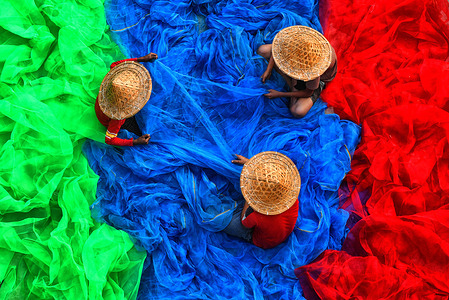 Fishermen seen stitching colourful fishing nets during the pre-fishing session. In the Indian Sundarbans, particularly along the western banks of the Matla River, rising sea levels and rapid coastal erosion are forcing fishermen and wildlife into shrinking territory. The sea level has increased by 35 centimeters annually over the past two decades, making it one of the fastest-eroding coastal regions globally. As land disappears, both humans and endangered Bengal tigers are being pushed into closer, often dangerous, proximity.
