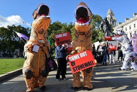 Protesters dressed like dinosaurs take part during a rally at Parliament Square.
LGBT community is calling on the public bodies and private companies who are members of Stonewall to come out of the charity scheme.