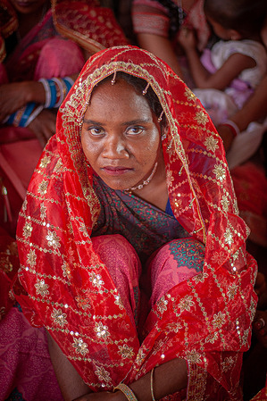A bride from a tribal community performs a ritual during a community-funded mass wedding of 121 couples. A community-funded mass wedding of 121 couples highlights the increasing reliance on collective ceremonies to bypass the prohibitive costs of traditional Indian marriages. These grassroots events offer a vital socio-economic lifeline, pooling local resources to provide financial relief for underprivileged families amid rising inflation.