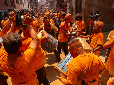 Nepalese devotees playing traditional musical instruments during the Festival. Sindoor Jatra or vermillion powder festival is celebrated each year to welcome the start of spring and Nepalese New Year, by playing a traditional instrument, singing, dancing, and carrying chariots of several gods and goddesses around the place.