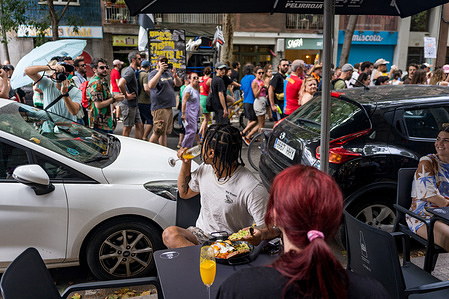 Tourists are seen sitting in a bar during the demonstration against mass tourism . With more than 20 million tourists expected in 2025, there is increasing contempt toward mass tourism among local citizens due to rising housing prices and overcrowding of the city during the tourist season.