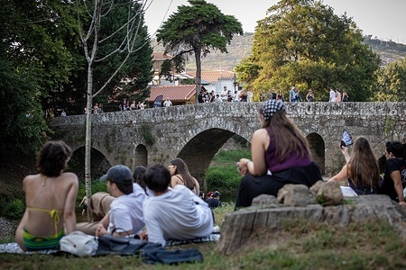 Festivalgoers walk across the Roman bridge in the surrounding area of the Vilar de Mouros Festival grounds during the opening day. Opening day of the Vilar de Mouros Festival 2026. Vilar de Mouros is one of the oldest music festivals in Portugal, often described as the country’s Woodstock.