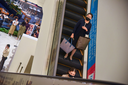 BANGKOK, THAILAND - MAY 14, 2020:
A woman wears a face mask as a preventive measure at Siam Paragon shopping mall amid coronavirus crisis.
After two month of Thailand shutdown due to the Covid-19 crisis. Shopping malls will reopen to the public with strict health and safety measures on May 17th.