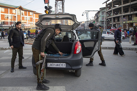 Indian security personnel search a car during a random search operation ahead of Republic Day. Authorities have heightened security across Kashmir for the 77th Republic Day to commemorate the adoption of India's constitution on January 26, 1950, utilizing drones, high-resolution CCTV, and intensified vehicle checks. These multi-tier measures are a direct response to specific intelligence warnings regarding an ISI-backed "26-26" terror plot and increased infiltration attempts along the Line of Control. By establishing round-the-clock checkpoints and conducting area domination exercises, security forces aim to neutralize potential threats and ensure a peaceful environment for the national celebrations.