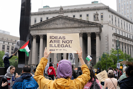 A protester holds a placard reading "Ideas Are Not Illegal" outside of the United States Court of Appeals for the Second Circuit in support of Tufts University student Rumeysa Ozturk and Columbia University student activist Mohsen Mahdawi. A panel of federal judges listened to arguments on court orders releasing Mahdawi and returning Öztürk from Louisiana to Vermont as legal challenges proceed.