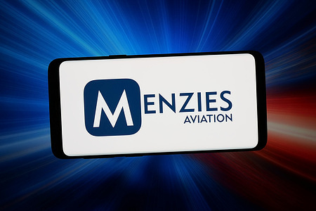 In this photo illustration, the logo of aviation services company Menzies Aviation is displayed on a smartphone in front of abstract background on computer screen.