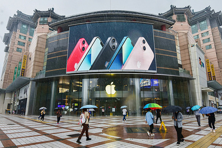 People walk past an apple store in Wangfujing with iPhone 13 series advertisement on a big screen.On September 24, 2021, the first batch of iPhone 13 series mobile phones are officially launched to be sold worldwide.