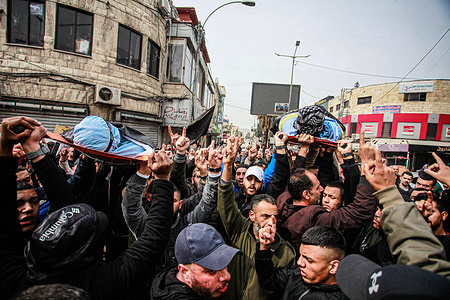 (EDITOR'S NOTE: Image depicts death)Gunmen are seen carrying the bodies of Said Jaradat and Yasser Hanoun, both wrapped in the flag of the Islamic Jihad militant group. The two Palestinians, Said Jaradat, and Yasser Hanoun, were killed in a car by an Israeli drone strike in the West Bank Jenin refugee camp a day earlier. The Israeli military claimed that Hanoun had been previously involved in several shooting attacks targeting Israeli settlements and army posts.