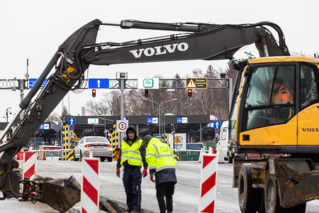 Road workers are seen at Polish-Ukrainian border crossing in Medyka as cars wait to enter Ukraine. 
As the Russian Federation army crosses Ukrainian borders the conflict between Ukraine and Russian is expected to escalate. The escalation is bound to create a wave of Ukrainian refugees of which most will seek asylum in Poland.