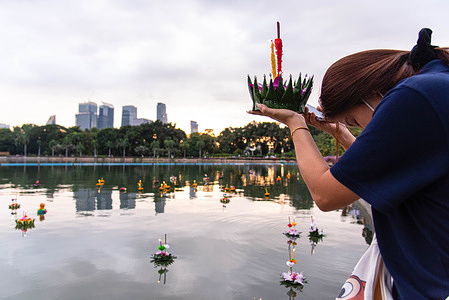 A devotee prays before releasing a "Krathong" during the Loy Krathong Festival at the Benjakitti Park. The annual Festival of Loy Kratong is held to pay respects to the goddess of the river. Devotees release small floats known as "Krathongs" into rivers, lakes and ponds.