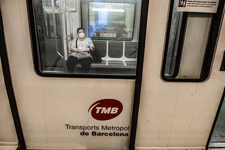 A man inside a train wearing a face mask as a preventive measure against the spread of Coronavirus (COVID-19).
The use of the sanitary masks are mandatory on public transport from Phase Zero. Vending machines with masks and hand hygiene products installed at five of the main metro stations in Barcelona.